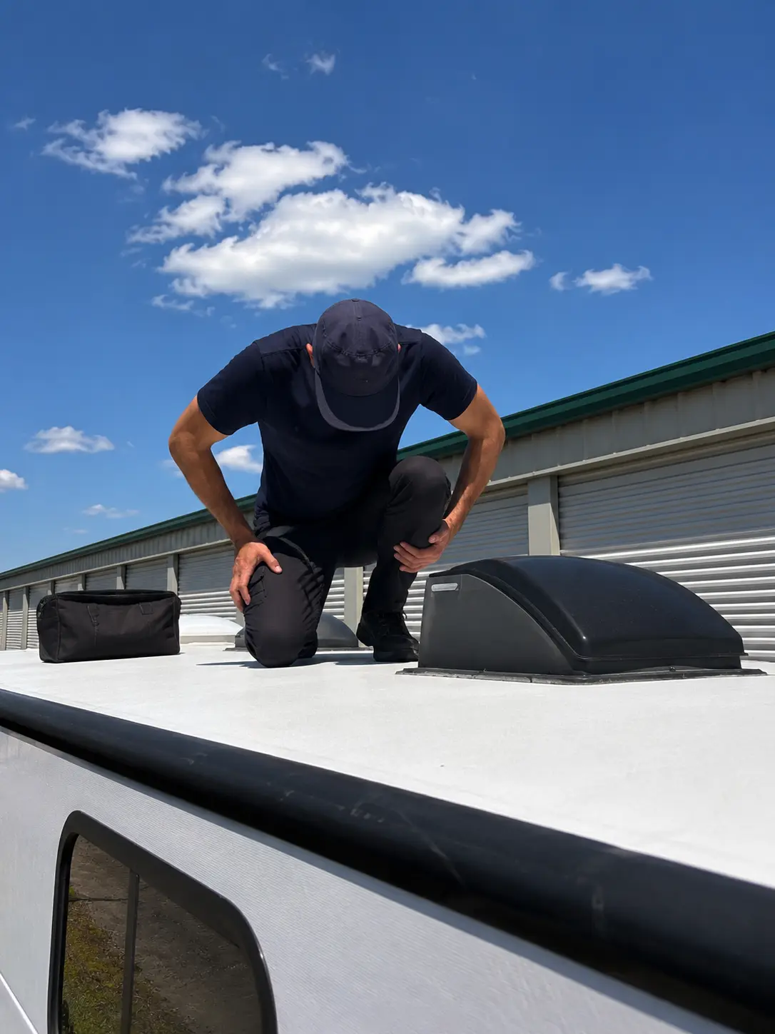 RV roof leak repair technician applying Dicor sealant on EPDM roof at storage facility in Cincinnati OH